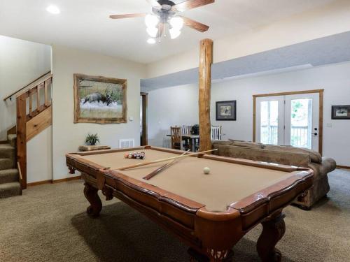 a living room with a pool table and a couch at Lodge 371 in Branson