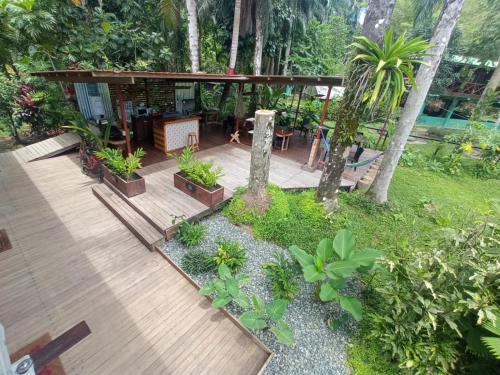 a wooden deck with plants in a garden at La Luciernaga Big Creek in Bocas del Toro