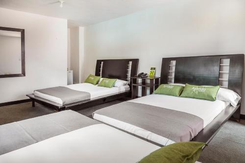מיטה או מיטות בחדר ב-Ayenda 1257 Premium Real