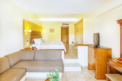 a hotel room with a bed and a couch at Hotel Europa Olympia in Olympia