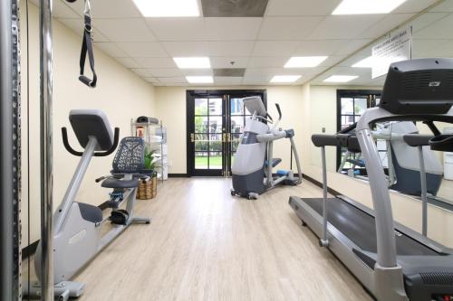 a gym with treadmills and elliptical machines at Oxford Suites Pismo Beach in Pismo Beach