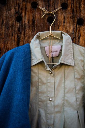 a white shirt and a blue shirt on a hanger at Boutique Hotel Al Palazzo Rosso in Neive