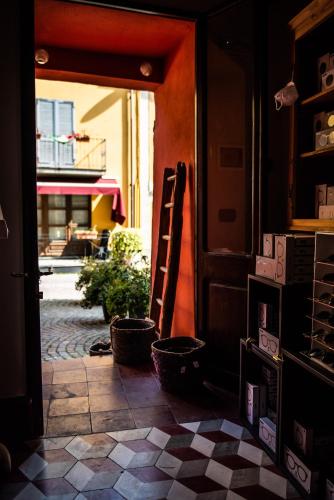 an open door to a room with a tile floor at Boutique Hotel Al Palazzo Rosso in Neive