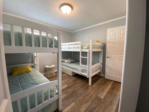 a small room with two bunk beds and a door at Steps away from the BEACH!!! in Hilton Head Island