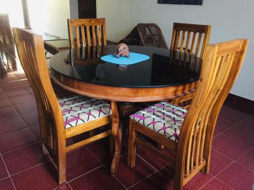 a table with a surfboard on top of it at Ganesh House Ayurveda Homestay in Kovalam