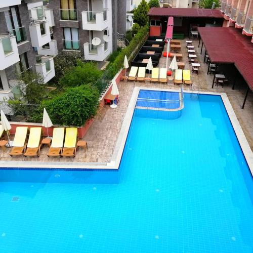 an overhead view of a swimming pool with lounge chairs and a building at Grand Nar Hotel ADULT ONLY - All Inclusive in Kemer