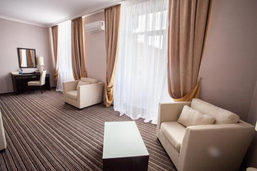 a living room with a couch and a chair and a table at Optima Sumy in Sumy