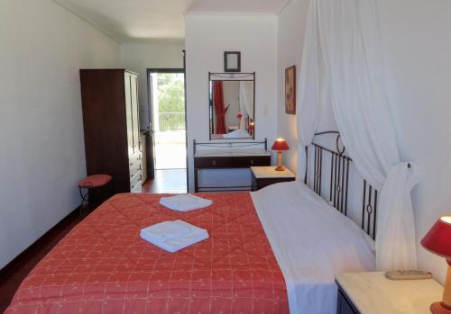 a bedroom with a large bed and a sink at Dionysos Hotel in Skala