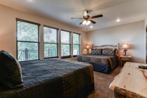 a bedroom with two beds and a ceiling fan at Lodge 73 in Branson