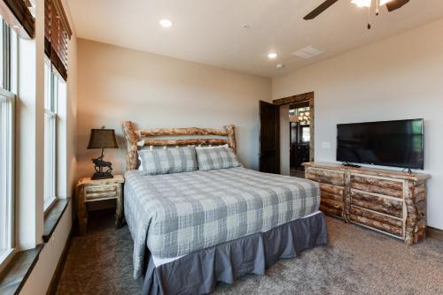 a bedroom with a bed and a flat screen tv at Lodge 73 in Branson