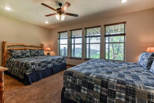 a bedroom with two beds and a ceiling fan at Lodge 73 in Branson