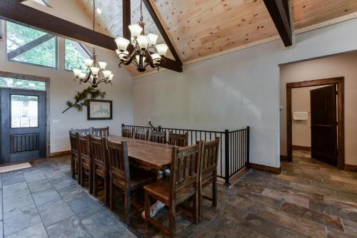 a dining room with a wooden table and chairs at Lodge 73 in Branson