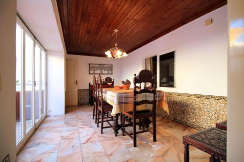 a dining room with a table and chairs at Casa Ocre in Vila Nova de Milfontes