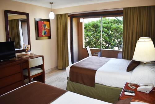 Postel nebo postele na pokoji v ubytování Hotel San Luis Lindavista