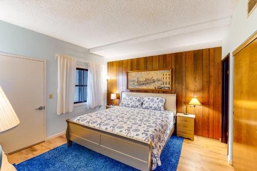 a bedroom with a bed and a blue rug at Sand and Sea #304 in Seaside
