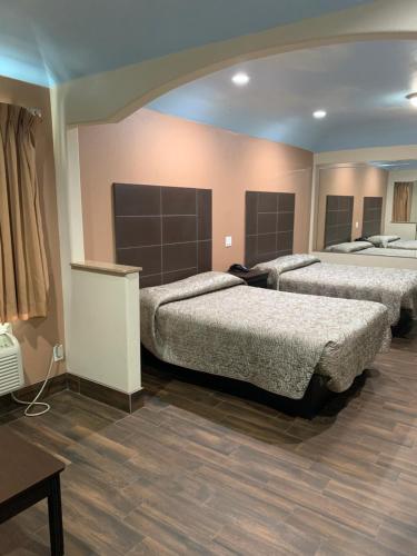a bedroom with two beds and a table at Sterling Inn and Suites at Reliant and Medical Center Houston in Houston