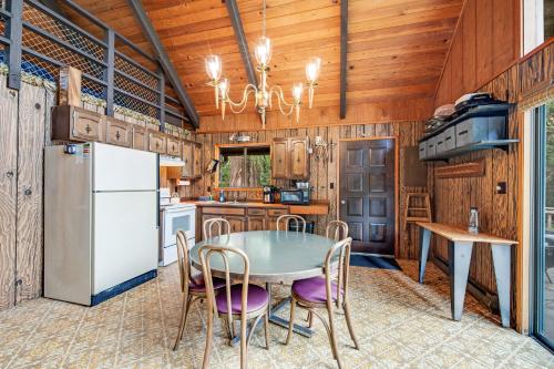 a kitchen with a table and chairs and a refrigerator at Hartstene Pointe Haven in Shelton