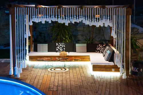 a bedroom with a bed with white drapes at Eva's Luxury Villa in Kritharia