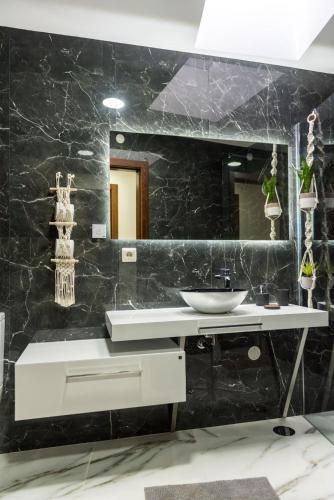 a bathroom with a sink and a mirror at Michel's house in Esposende