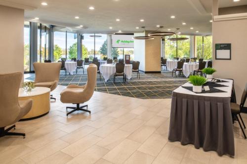 a meeting room with tables and chairs in a building at Holiday Inn Richland on the River by IHG in Richland