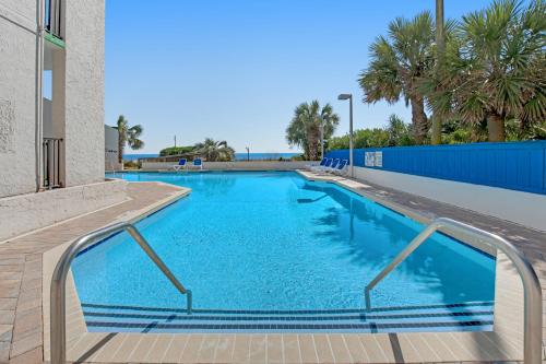 a swimming pool with blue water in a building at Ocean Park Resort - Oceana Resorts Vacation Rentals - by Vacasa in Myrtle Beach