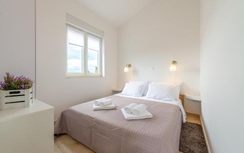 Ένα ή περισσότερα κρεβάτια σε δωμάτιο στο Apartmani Opg Dragoslavić