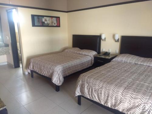 a hotel room with two beds in a room at Jalyd Inn in Irapuato