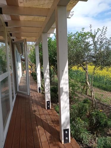 a porch with white columns and a glass door at La Casa di Tara B&B Armonia e Natura in Recanati