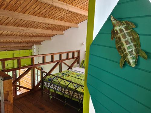 a room with a bed and a balcony at Almost Paradise Cottage Retreats in Sauteurs