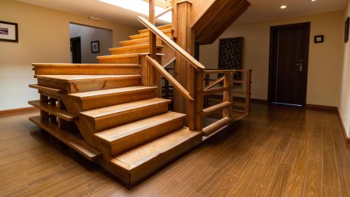 a wooden staircase in a living room with wooden floors at Hotel Poincenot in El Chalten