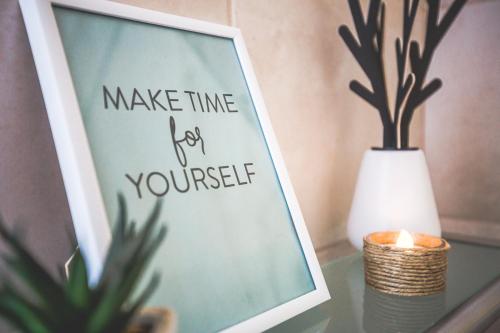 a picture on a table with a candle and a plant at Sweet Life Gozo - Boutique Living in Santa Luċija