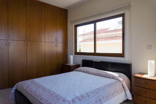 a bedroom with a bed and a window at Chara Elizabeth No 2 Villa in Protaras