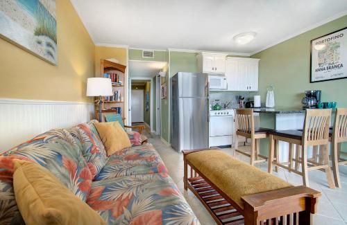 a living room with a couch and a kitchen at Nothing But Ocean in Forest Beach in Hilton Head Island