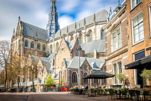a large building with a clock tower in the background at RiverSide Suite - Haarlem City Centre in Haarlem