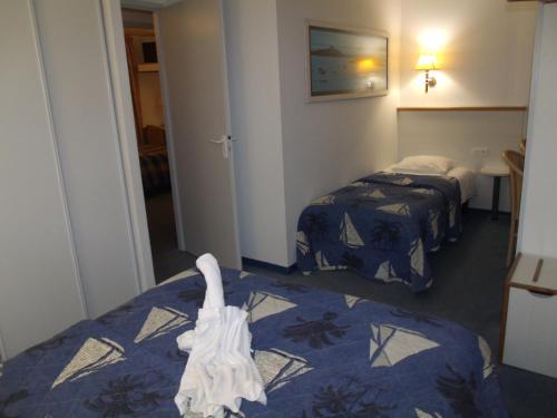 Ένα ή περισσότερα κρεβάτια σε δωμάτιο στο Hotel De La Mer