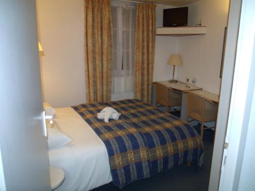 Cama ou camas em um quarto em Hotel De La Mer