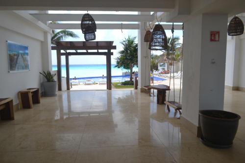a lobby with a view of the beach and the ocean at Ocean View Condo in Cancún