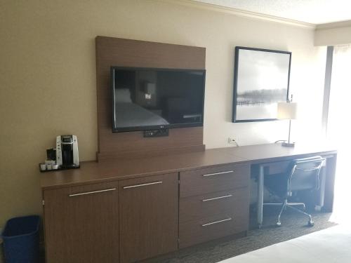 a desk in a hotel room with a tv and a desk with a desk at Holiday Inn Express Edmonton Downtown by IHG in Edmonton