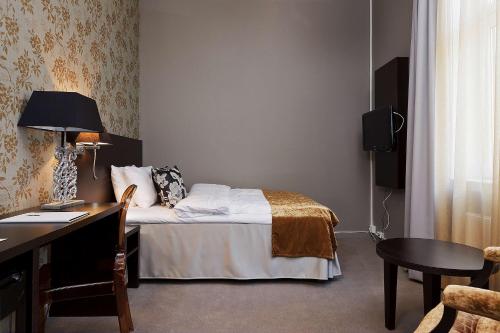 
a bedroom with a bed and a desk at Saga Hotel Oslo; BW Premier Collection in Oslo
