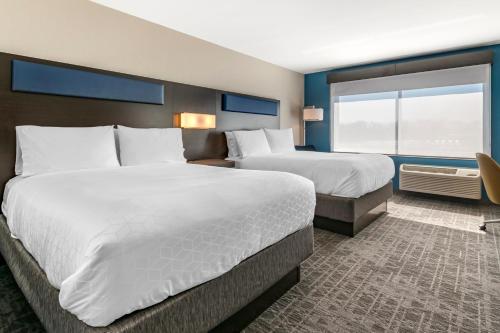 a hotel room with two beds and a window at Holiday Inn Express & Suites - Carlisle Southwest I-81 by IHG in Carlisle