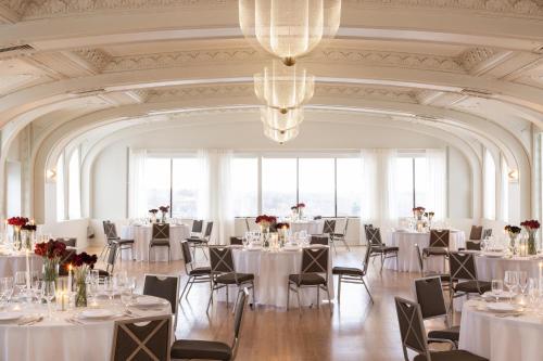 a banquet hall with white tables and chairs at Kimpton Cottonwood Hotel by IHG in Omaha