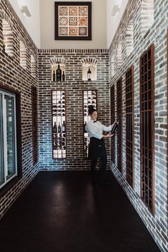 a man standing in a room with brick walls at Serafino McLaren Vale in McLaren Vale