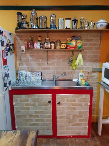 a kitchen with a sink and a brick wall at UNIQUE 1920's Historic Retreat! Pet Friendly! in Springwood