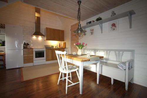 a kitchen with a table and chairs in a room at Hallagärde Gård in Frillesås