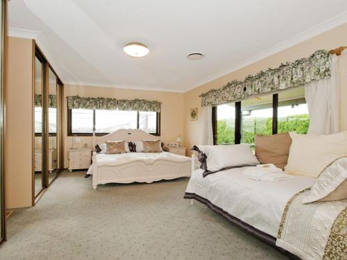 a bedroom with two beds and two windows at Hope in Exeter