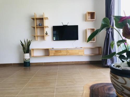 a living room with a flat screen tv on a wall at Casa Vi Mia in Ấp Thiện Sơn