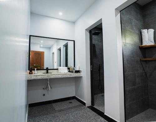 a bathroom with a sink and a mirror at Kampot Sweet Boutique in Kampot