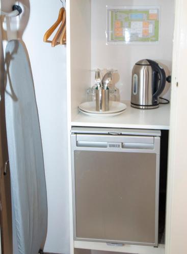 a small kitchen with a stove and a sink at Rosebridge House Bed & Breakfast Adult Retreat in Gooseberry Hill