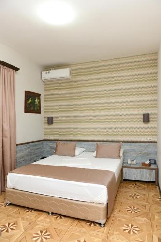 a bedroom with a bed in a room at Yerevan Boutique Hotel in Yerevan