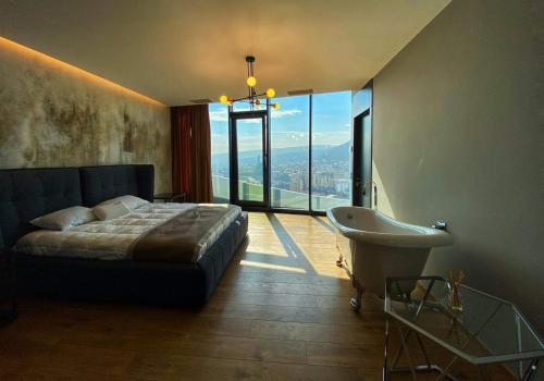 a bedroom with a bed and a tub and a sink at Tbilisi view in Tbilisi City